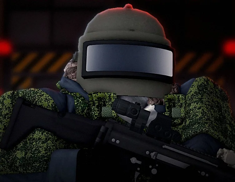 A soldier in a visored assault helmet and camouflage, rifle ready, in a red-lit bunker